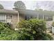 Modest home exterior with vinyl siding, covered porch, and landscaped yard at 177 New Hope Cir, Fayetteville, GA 30214