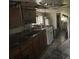 Incomplete kitchen featuring wood cabinets, a sink, and a range, visible signs of disrepair and needed renovation at 177 New Hope Cir, Fayetteville, GA 30214