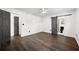 Bedroom features hardwood floors, white walls, barn door closet, and a gray door to the bathroom at 2302 Aurie Dr, Decatur, GA 30034