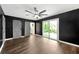 Stylish bedroom featuring dark accent walls, sliding barn doors, and a sliding glass door to the backyard at 2302 Aurie Dr, Decatur, GA 30034