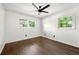 Bright bedroom with hardwood floors, a ceiling fan, and two windows providing natural light at 2302 Aurie Dr, Decatur, GA 30034