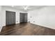 Spacious bedroom with dark wood-look floors, white walls, multiple closets, and ceiling fan at 2302 Aurie Dr, Decatur, GA 30034