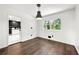 Dining area with dark floors, modern pendant lighting, a window with outside views and adjoining kitchen at 2302 Aurie Dr, Decatur, GA 30034