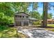 Charming two-story home featuring a gray brick facade, two-car garage, and well-maintained lawn at 2302 Aurie Dr, Decatur, GA 30034