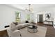 Bright living room featuring a modern chandelier, neutral walls, and wood floors at 2302 Aurie Dr, Decatur, GA 30034