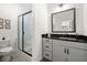Modern bathroom featuring a sleek black-framed shower and a stylish vanity with black countertops at 383 Pratt Se Dr # 506, Atlanta, GA 30315