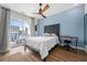 Bright bedroom with a ceiling fan, modern desk and access to a private outdoor balcony at 383 Pratt Se Dr # 506, Atlanta, GA 30315
