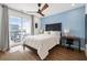 Bright bedroom with a bed, a desk, and a balcony with a view at 383 Pratt Se Dr # 506, Atlanta, GA 30315
