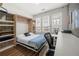 Bright bedroom with a Murphy bed, featuring built-in shelving, a desk area, and natural light at 383 Pratt Se Dr # 506, Atlanta, GA 30315