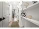 Hallway with custom shelves featuring stylish decor leading to an open living space with natural light at 383 Pratt Se Dr # 506, Atlanta, GA 30315