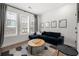 Comfortable living room featuring modern decor, a plush sofa, and large windows with neighborhood views at 383 Pratt Se Dr # 506, Atlanta, GA 30315