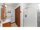 Bathroom featuring a glass shower, wooden cabinets, and coordinated fixtures at 9186 Puckett St, Covington, GA 30014
