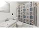 Bright bathroom features a shower and tub combination with a stylish shower curtain at 9186 Puckett St, Covington, GA 30014