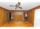Bedroom with hardwood floors, wood paneled walls, ceiling fan, and closet at 9186 Puckett St, Covington, GA 30014