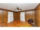 Spacious bedroom with hardwood floors, wood paneled walls, and dual windows at 9186 Puckett St, Covington, GA 30014