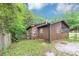 Rear exterior view of a charming home with a screened-in porch and brick accents at 9186 Puckett St, Covington, GA 30014