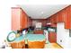 Spacious kitchen featuring wooden cabinets and speckled countertops with chairs at 9186 Puckett St, Covington, GA 30014