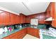 Functional kitchen with wood cabinets, green countertops, and ample counter space at 9186 Puckett St, Covington, GA 30014