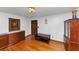Inviting living room with beautiful hardwood floors, elegant light fixture, and dark wood furniture at 9186 Puckett St, Covington, GA 30014