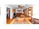 Bright living room with hardwood floors, built-in shelving and a ceiling fan at 9186 Puckett St, Covington, GA 30014