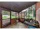 Relaxing screened patio with chairs and a table overlooking the lush backyard at 9186 Puckett St, Covington, GA 30014