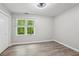 Bedroom with wood-look floors, one window, and a double door closet at 1520 N Milford Creek Sw Ln, Marietta, GA 30008