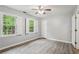Bedroom featuring hardwood style floors, two shuttered windows and a ceiling fan at 1520 N Milford Creek Sw Ln, Marietta, GA 30008
