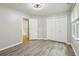 Bedroom with wood-look floors, large closet, and a window for natural light at 1520 N Milford Creek Sw Ln, Marietta, GA 30008