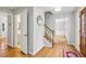 Inviting entryway featuring hardwood floors, staircase, and access to the bathroom at 1520 N Milford Creek Sw Ln, Marietta, GA 30008