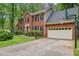 Two-story brick home with a two-car garage and basketball hoop on a sunny day at 1520 N Milford Creek Sw Ln, Marietta, GA 30008