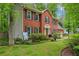 Charming two-story brick home with black shutters and a well-manicured front lawn at 1520 N Milford Creek Sw Ln, Marietta, GA 30008