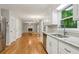 View of open floor plan from kitchen featuring granite countertops, sink and stainless steel appliances at 1520 N Milford Creek Sw Ln, Marietta, GA 30008