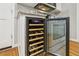 Kitchen featuring built-in wine cooler adjacent to oven with hardwood floors at 1520 N Milford Creek Sw Ln, Marietta, GA 30008