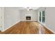 Cozy living room featuring hardwood floors, fireplace, and a large window at 1520 N Milford Creek Sw Ln, Marietta, GA 30008