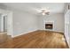 Open living room with hardwood floors, fireplace, and natural light from large windows at 1520 N Milford Creek Sw Ln, Marietta, GA 30008
