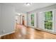 Bright living room featuring hardwood floors and large windows with white shutters at 1520 N Milford Creek Sw Ln, Marietta, GA 30008