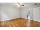 Large main bedroom with hardwood floors, a ceiling fan, and a door to ensuite bath at 1520 N Milford Creek Sw Ln, Marietta, GA 30008