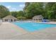 Community pool with ample concrete deck space, shaded gazebo, and separate changing and restroom facilities at 1520 N Milford Creek Sw Ln, Marietta, GA 30008