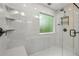 Modern shower features stone-look walls, a built-in bench, and a glass door at 1520 N Milford Creek Sw Ln, Marietta, GA 30008
