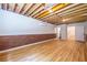 Unfinished basement with exposed beams, brick accents, laminate flooring, and access to other rooms at 333 Mimosa Dr, Decatur, GA 30030