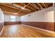 Unfinished basement with exposed beams, brick walls, laminate flooring, and natural light at 333 Mimosa Dr, Decatur, GA 30030