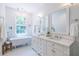 Bright bathroom showcasing a soaking tub, double vanity, and elegant fixtures at 333 Mimosa Dr, Decatur, GA 30030