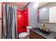 Modern bathroom with red subway tile, gold fixtures, a sleek vanity, and a stylish shower curtain at 333 Mimosa Dr, Decatur, GA 30030