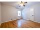 Simple bedroom featuring hardwood floors, a ceiling fan, and large windows at 333 Mimosa Dr, Decatur, GA 30030