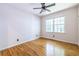 Bright bedroom featuring beautiful hardwood floors, a modern ceiling fan, and a large window at 333 Mimosa Dr, Decatur, GA 30030