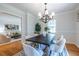 The bright dining room includes trendy lighting, neutral paint, hardwood flooring, and a view to the living room at 333 Mimosa Dr, Decatur, GA 30030