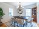 Bright dining room with hardwood floors, area rug and a modern lighting fixture above the dining table at 333 Mimosa Dr, Decatur, GA 30030