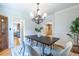 The stylish dining room features modern lighting, neutral paint, hardwood flooring, and seating for six at 333 Mimosa Dr, Decatur, GA 30030