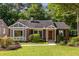 Charming brick home featuring a well-manicured lawn, complemented by lush greenery and a welcoming entrance at 333 Mimosa Dr, Decatur, GA 30030
