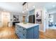 Open floor plan with view of the light blue kitchen island, hardwood floors, and stainless refrigerator at 333 Mimosa Dr, Decatur, GA 30030